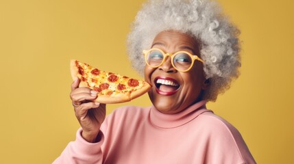 Happy senior Afro woman enjoys pizza in a studio.