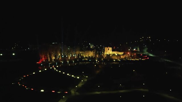 Dobele Livonia Order Castle Ruins in Latvia 105 Birthday, 18 November 2023, Illuminated With Colored Rays of Light With Reflections in Berze River. Castle and Park Illuminated With Lights at Night
