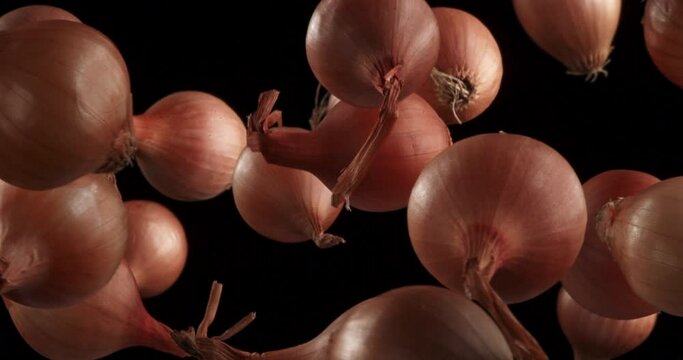 onions in the air on black background