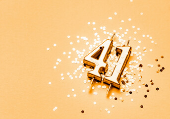 41 years birthday celebration festive background made with golden candle in the form of number...