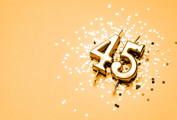 45 years birthday celebration festive background made with golden candle in the form of number...