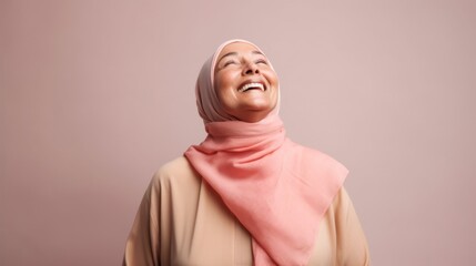 Happy cancer survivor in pastel attire poses in a studio.