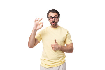Naklejka premium young caucasian man with black hair and beard looks at the camera in surprise