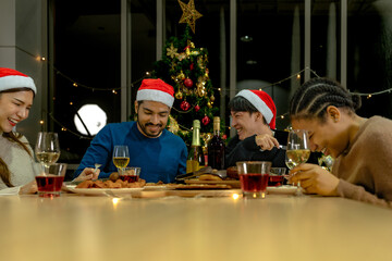 Party of beautiful asian friend female and male celebrating. freind serving pizza on table with snack and drink. happiness friends christmas eve celebration dinner party food and champagne.
