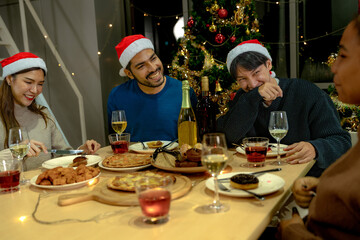 Party of beautiful asian friend female and male celebrating. freind serving pizza on table with snack and drink. happiness friends christmas eve celebration dinner party food and champagne.
