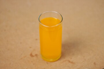 Full glass of orange juice close-up. Fresh orange juice on wooden table