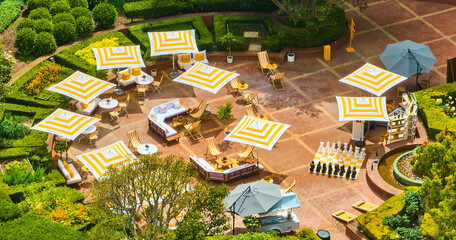 Perfect getaway vacation with yellow and whit themed resort courtyard aerial on sunny summer day, CA - obrazy, fototapety, plakaty