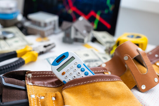 Leather tool belt with construction tooling on wooden board maintenance concept.