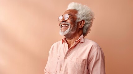 Senior man exudes joy against a soft studio background.