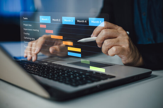 Project manager working and update tasks with milestones progress planning. Businessman using laptop computer plan schedule virtual diagram, business project management concept.