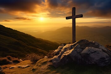  a cross sitting on top of a large rock in the middle of a grassy field next to a mountain under a cloudy sky with a sun setting in the distance.