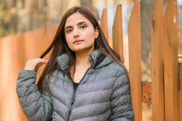 Close up portrait of pretty indian young woman enjoying warm autumn sunny day vacation outdoor copy space mockup. Generation z and gen z concept. Fall Season