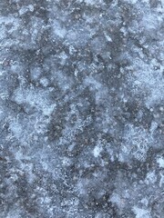 Ice on the ground. Textured winter background. Cold weather, frost.
