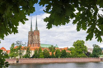 View of Tumski island with Collegiate Church of the Holy Cross and St. Bartholomew Wroclaw historical capital of Silesia in Poland - obrazy, fototapety, plakaty