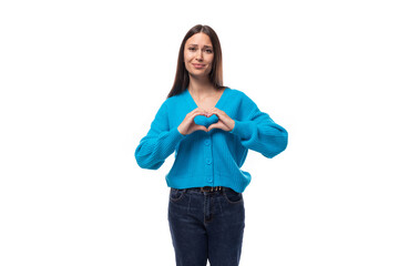 young cheerful smiling brunette woman with light make-up is dressed in a blue button-down sweater on a white background