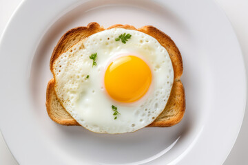 a fresh fried egg with bright yellow yolk on a slice of toast
