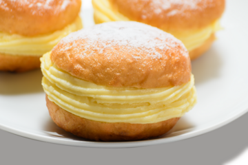 three bakery dreams on a white plate against 