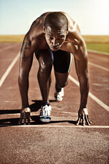 Portrait, man and ready for race, track and field with practice for competition. Olympics, male runner or athlete with determination on face for sprint, performance or sport by commitment for fitness