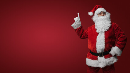Surprised Santa Claus gesturing with both hands, expressing holiday excitement