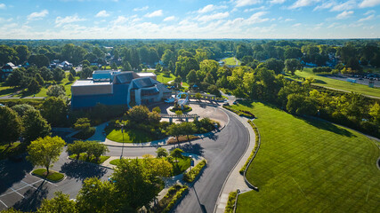 Wide aerial Minnetrista Museum and Gardens on bright, sunny summer day with cloudy blue sky