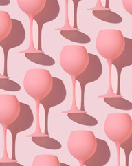 Pink colored wine glasses as trend minimal pattern, monochrome pastel color, romance event or valentine party concept. Creative aesthetic top view of cocktail drink pink background, girly style