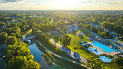 Tuhey Pool aerial with neighborhood beside White River on sunny late afternoon, Muncie IN
