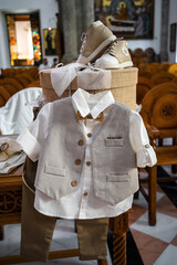 Brown and beige-toned boy's baptismal suit, a charming outfit for a special ceremony. Selective foocus.