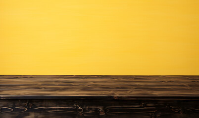 Wooden product mockup board empty table in front of yellow wallpaper background