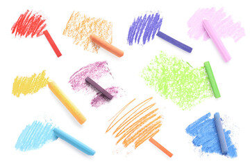 Colorful soft pastels and scribbles on white background, top view. Drawing supply