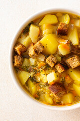 Pea soup with fried croutons, healthy bean soup, top view