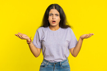 What. Why. Angry Indian woman raising hands in indignant expression, asking reason of failure, demonstrating disbelief irritation by troubles. Arabian young girl isolated on yellow studio background - obrazy, fototapety, plakaty