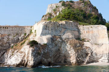 Fototapeta na wymiar Cliffs with ancient walls near the Mediterranean Sea, Corfu
