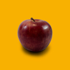 red apple on yellow background