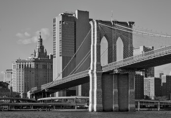 brooklyn bridge view over hudson river with nyc skyline background (urban cityscape of manhattan) black and white, dramatic, contrast monochrome detail