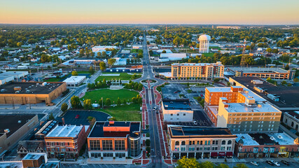 Canan Commons Park aerial at dawn with Muncie city buildings in aerial with water tower, IN