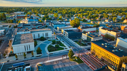 Delaware County Court Administration courthouse building and Muncie, IN city aerial at sunset