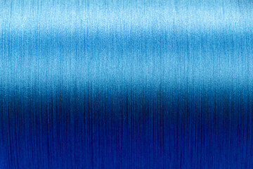 Closed up of blue color of thread textured background (Focus at center of picture)