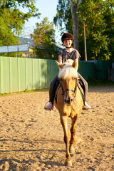 Portrait of teenage girl  on horseback wearing