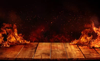 Tableaux sur verre Feu Wooden Table with Fire burn at the edge of the table, sparks, fire particles, and smoke in the air, with fire flames on a dark background to display hot and spicy products