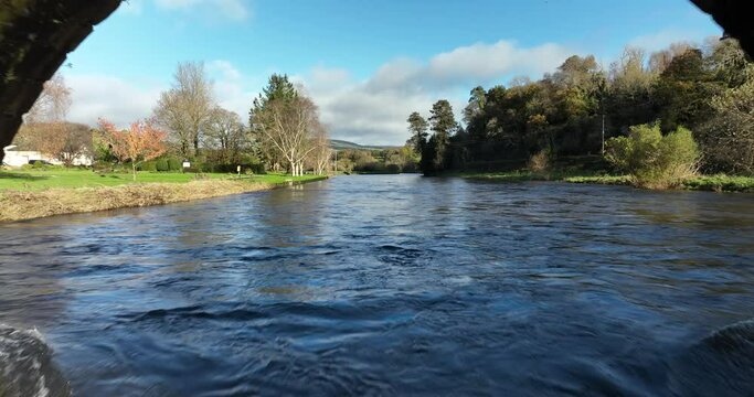 A drone flies under an 18th-century bridge over a river 4k