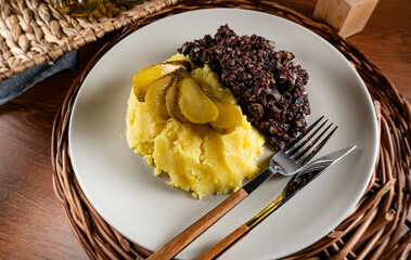 Fried black pudding with mashed potatoes.