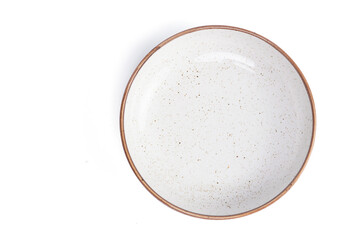 Fototapeta na wymiar beige round ceramic plate with dotted isolated on a white background. top view