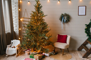 Modern Christmas tree with lots of lights and minimalist decoration in the Scandinavian living room
