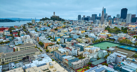 Obraz premium Sports tennis courts in San Francisco city, CA aerial with Coit Tower and skyscrapers