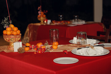 Chinese New Year dinner set up place with ornaments, fresh citrus fruits, decorated with traditional blooming peach branches