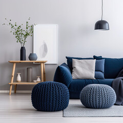 Two knitted poufs near dark blue corner sofa. Scandinavian home interior design of modern living room. 