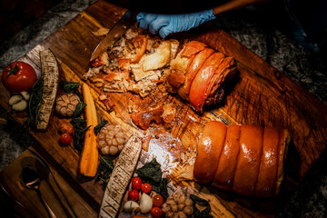 Carving station with meat variety among catering banquet table. Variety of snacks, appetizers, seafood and cooked meals displayed as buffet for wedding, Christmas, business corporate, birthday party