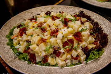Salad bar among catering banquet table. Variety of snacks, appetizers, seafood and cooked meals displayed as buffet for wedding, Christmas, business corporate, birthday party or other event