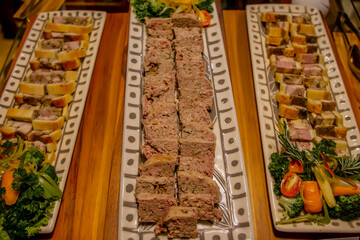 Catering banquet table with different food. Variety of snacks, appetizers, seafood and cooked meals displayed as buffet for wedding, Christmas, business corporate, birthday party or other event