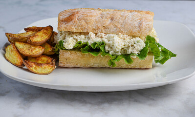chicken salad on  ciabatta  with potato wedges